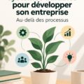 Une femme concentrée travaillant sur son ordinateur avec un tableau de gestion de systèmes en arrière-plan, symbolisant l'organisation d'entreprise.